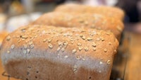 three loaves of bread sitting on a rack